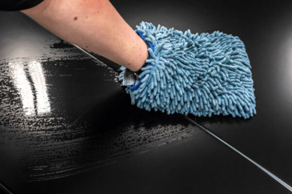 wiping black hood with hand mop